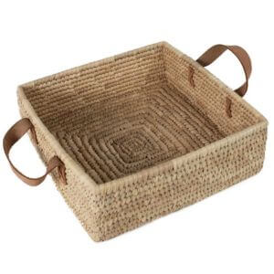 Square woven basket with handles on a white background.